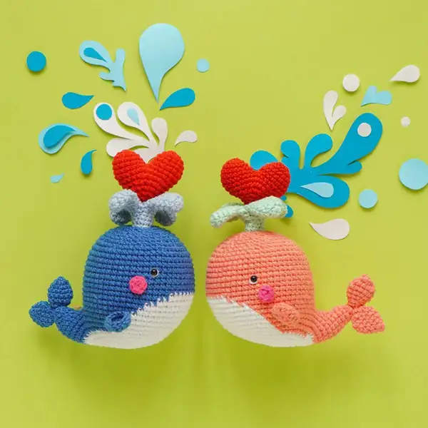 Two Cupid Whale amigurumi figures posed together