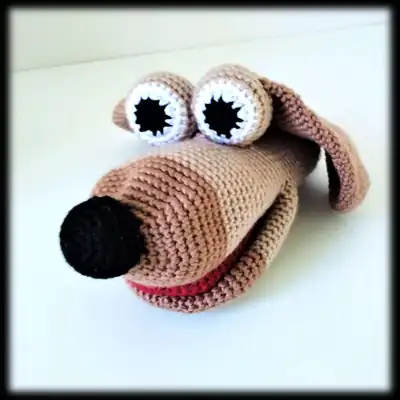 Brown dog hand puppet amigurumi close-up eyes