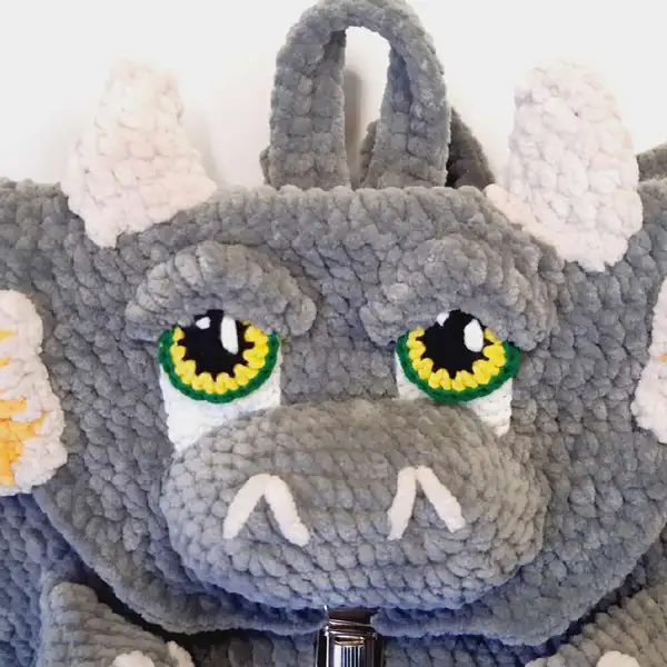 Close-up of orange spikes and white trim along the backpack edge
