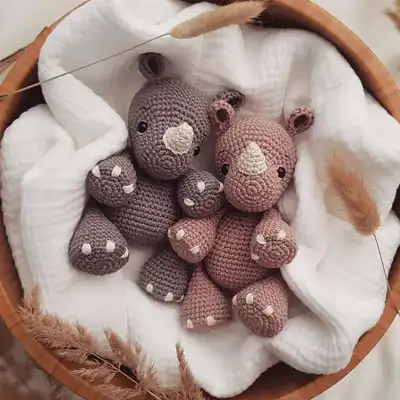 Pino rhino amigurumi in a soft basket, front view