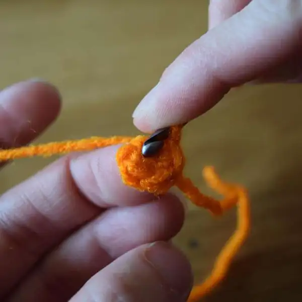 Close-up of top lid being attached to carrot body