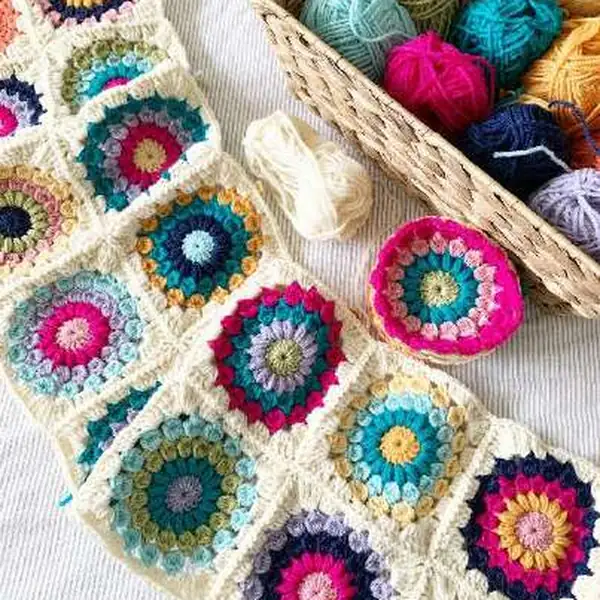 Blanket on a bed with a sunny, coastal motif arrangement