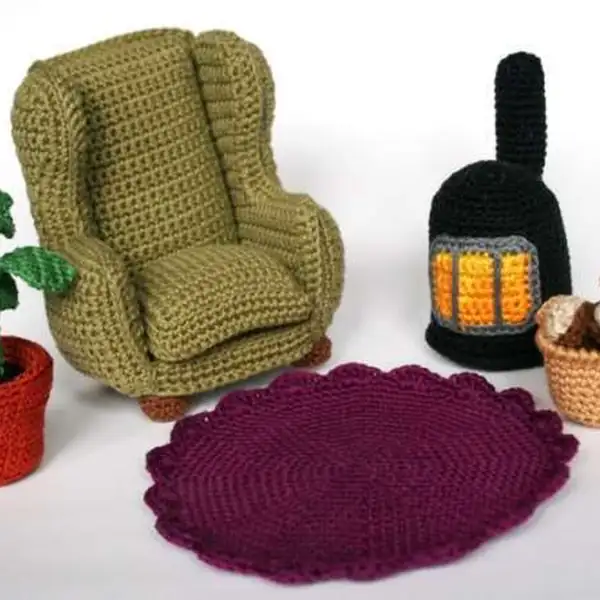 Crochet lamp beside a small TV stand
