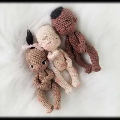 Close-up of skin-tone head of amigurumi baby doll