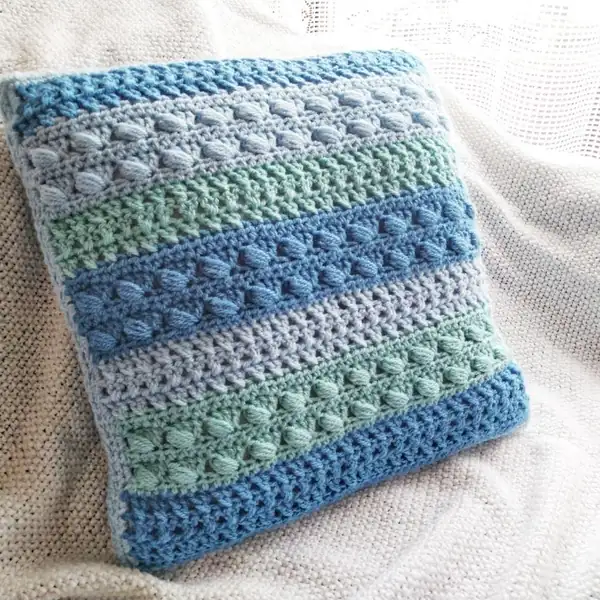Edge round detail on the cushion showing double crochet corner clusters and even side spacing amigurumi panel