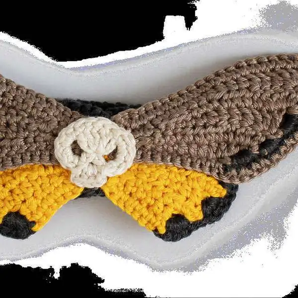 Assembly photograph showing layered wings and caterpillar body ready to be joined on the amigurumi moth