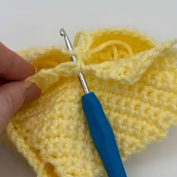 Hands stitching edging around the heart panels