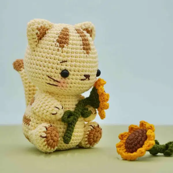 Group of cat and floral amigurumi pieces together