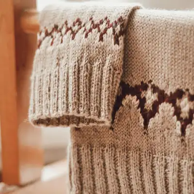 Front view of Guell Girls crochet sweater in natural yarn color