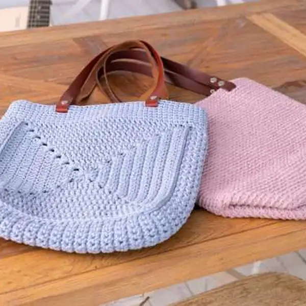Bag with leather handles laid flat