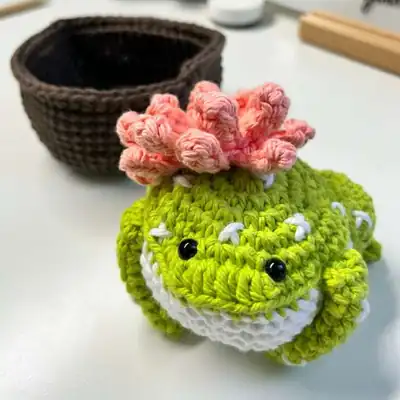 Lime green cactus frog amigurumi head with pink flower crown