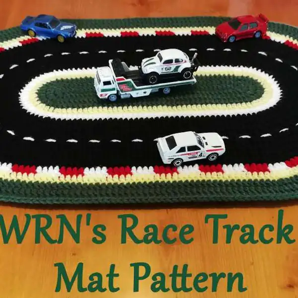 Backside close-up showing carried yarn and neat joins on the race track crochet mat