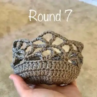 Boho Bag Saver hanging on a wall hook showing the full lacy body amigurumi-style display