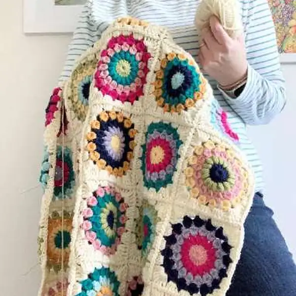 Finished Island Time Blanket draped over a chair with a white background