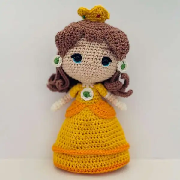 Blue overall body with joined legs and a crochet hook in the image, illustrating the body joining step for amigurumi