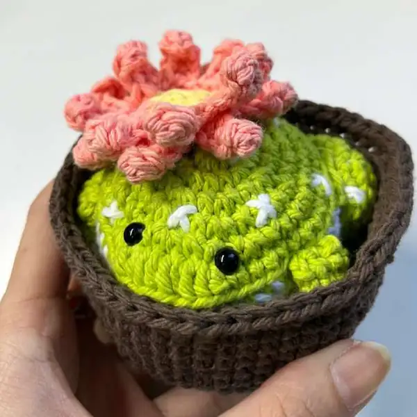 Frog seated in removable brown pot