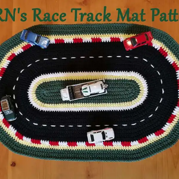 Detail of alternating red and white border blocks on the crochet race track mat