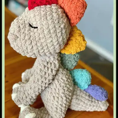 Sleepy Snuggle-saurus head close-up amigurumi in pale gray
