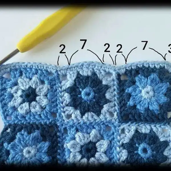 Granny square blanket laid out with a bunny toy
