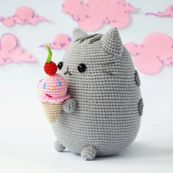 Ice cream cone prop held by crocheted paws