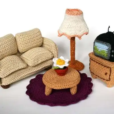 Beige sofa with cushions in a tiny crochet living room