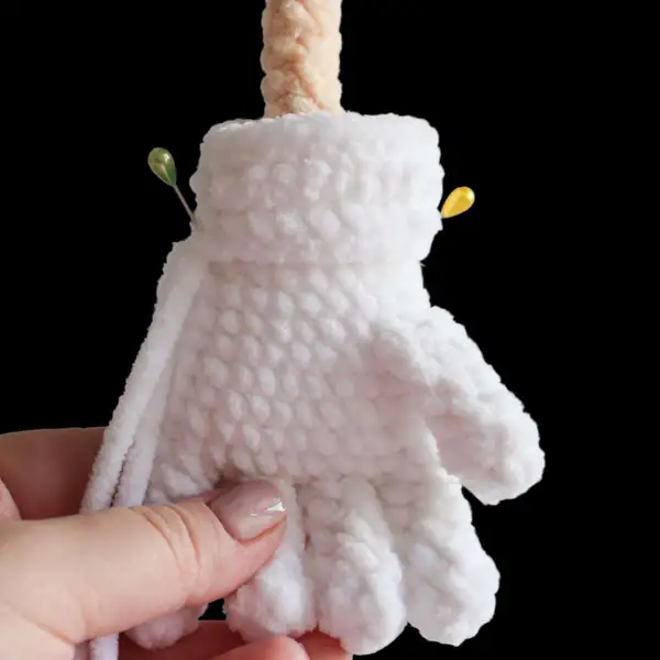 Close-up of the joined legs and sneakers of the Super-Prickle crochet amigurumi, showing red shoes and blue ankles.