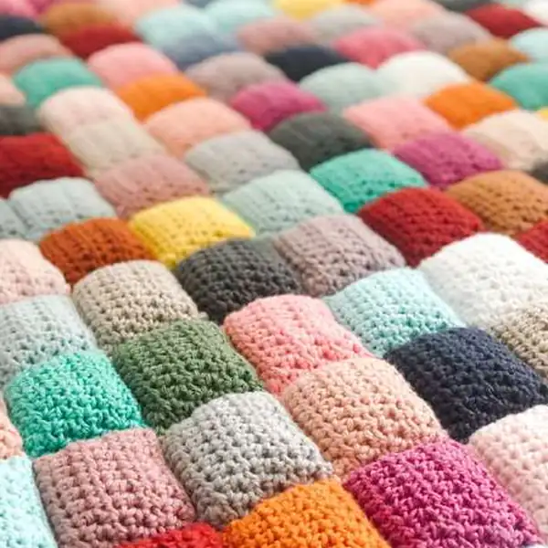 Seaming two puff squares together using mattress stitch on the puff quilt