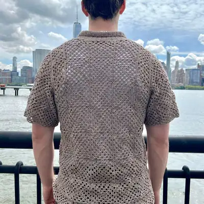 Front view of Amalfi crochet top on model showing buttoned square panel design and short sleeves crochet top