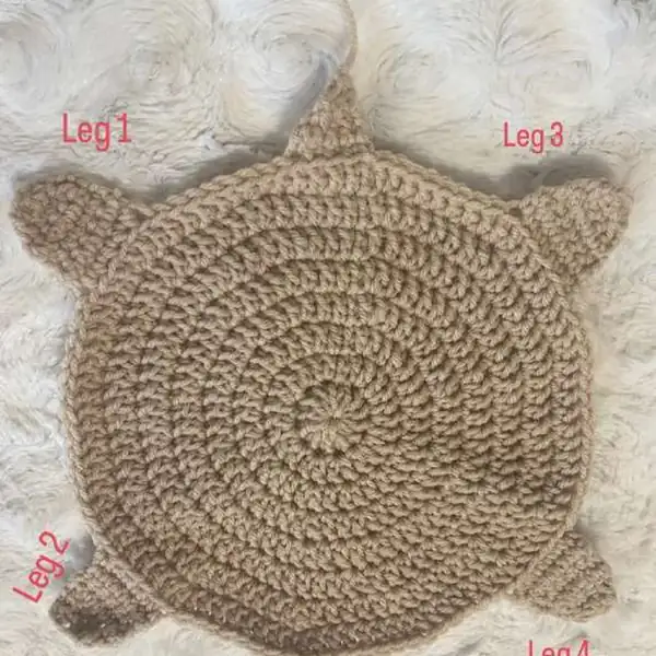 Mama turtle bottom shell worked in tan yarn laid flat to show round increases and leg placement
